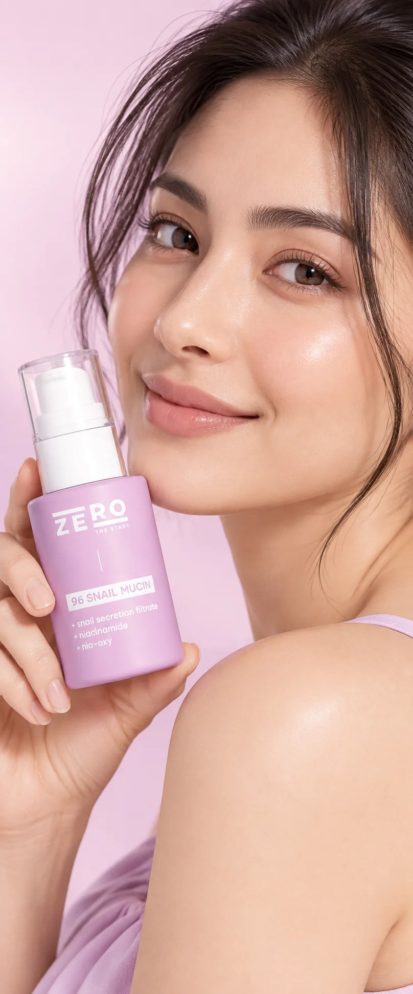 Woman holding Zero The Start 96 Snail Mucin serum against a pink background