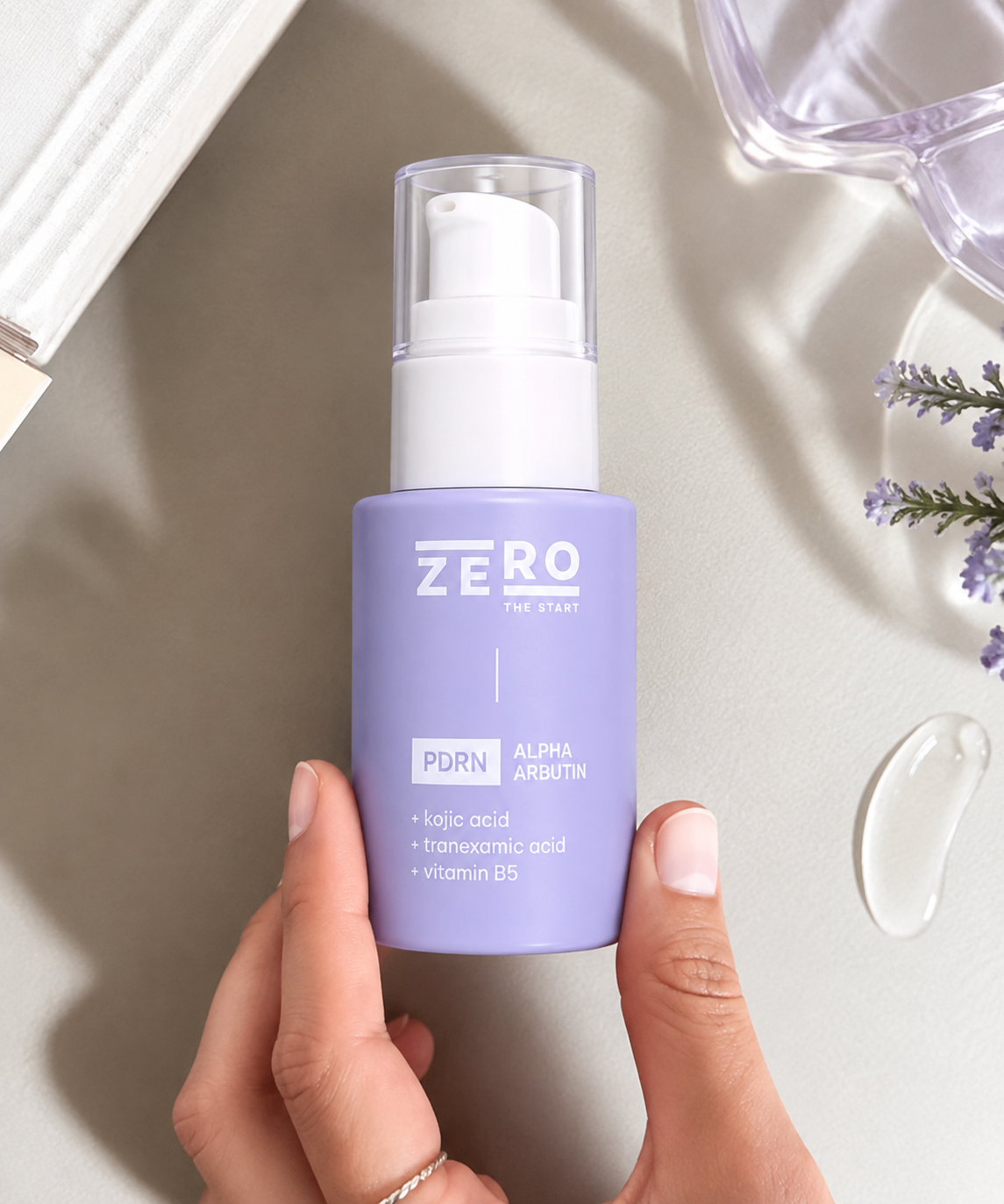 Zero The Start PDRN Alpha Arbutin serum bottle held by hand with skincare serum drop